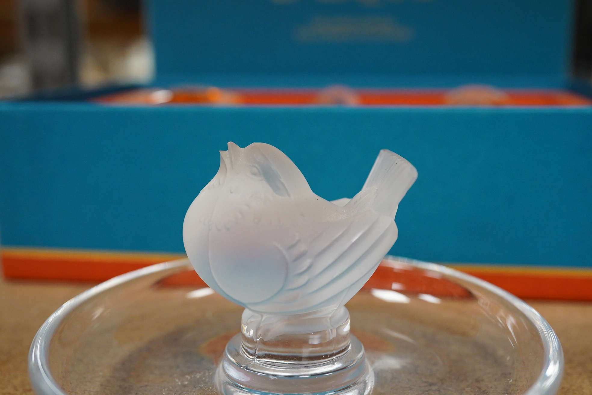 A Lalique bird pin dish and a Lalique perfume trio, Les Introuvables, in original box, pin dish 9cm